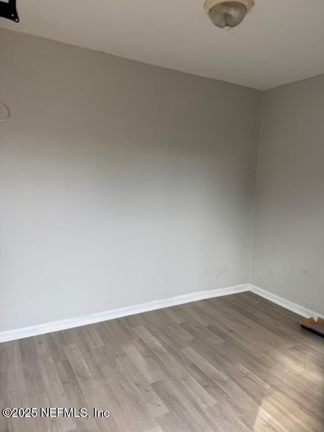 spare room with hardwood / wood-style flooring