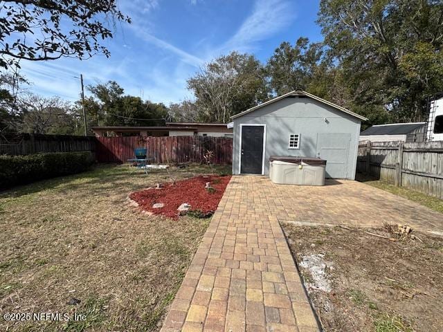 view of yard with a patio and an outbuilding