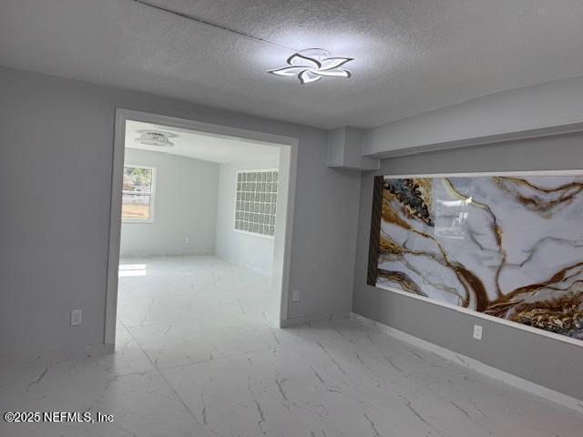 empty room featuring a textured ceiling