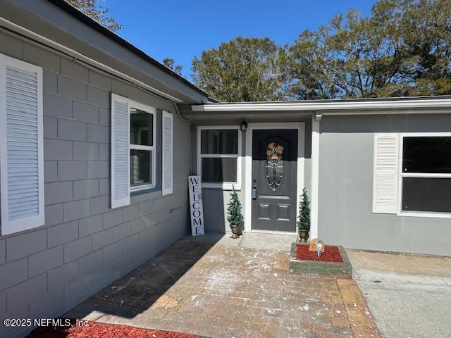 property entrance with a patio area