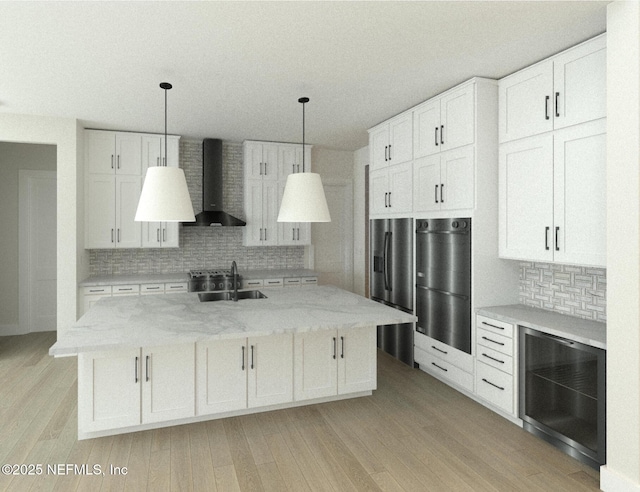 kitchen featuring white cabinets, sink, and wall chimney exhaust hood