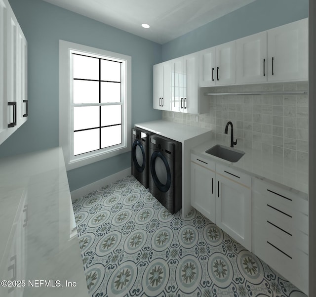 laundry room with cabinets, light tile patterned flooring, separate washer and dryer, and sink