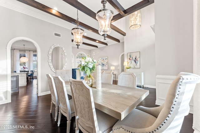 dining room with dark hardwood / wood-style flooring, a notable chandelier, and beamed ceiling