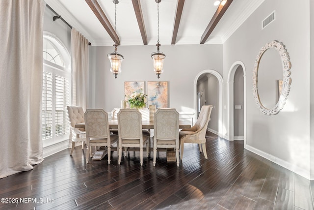 dining space featuring beamed ceiling and dark hardwood / wood-style flooring