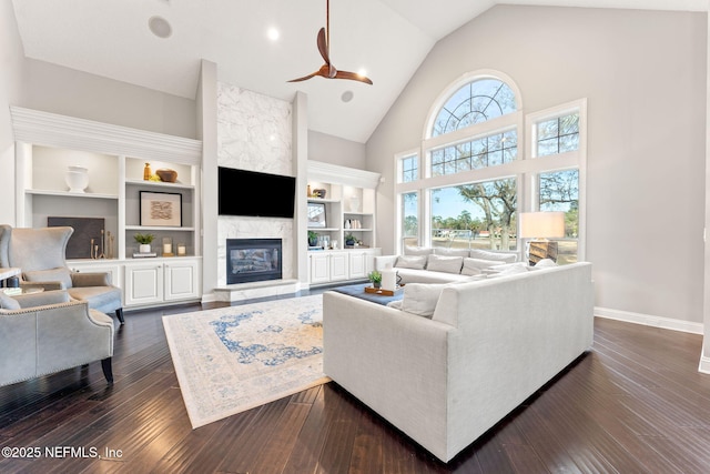 living room featuring dark wood-type flooring, a fireplace, and high vaulted ceiling