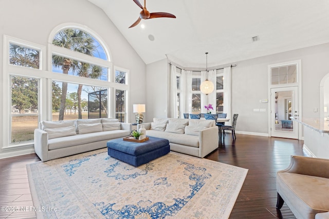 living room featuring ceiling fan, dark hardwood / wood-style floors, and high vaulted ceiling