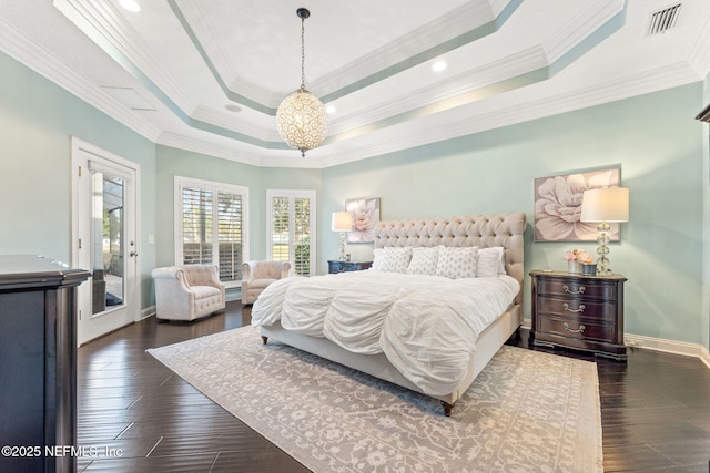 bedroom with crown molding, a notable chandelier, a tray ceiling, and dark hardwood / wood-style floors