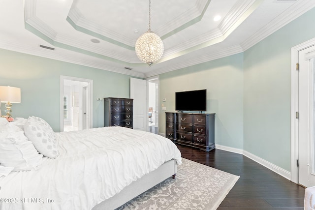 bedroom featuring dark hardwood / wood-style floors, ornamental molding, and a raised ceiling