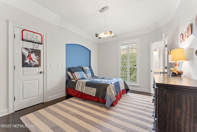 bedroom featuring crown molding, dark wood-type flooring, and a textured ceiling