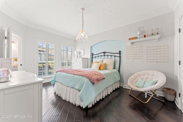 bedroom with crown molding, dark hardwood / wood-style floors, and a textured ceiling