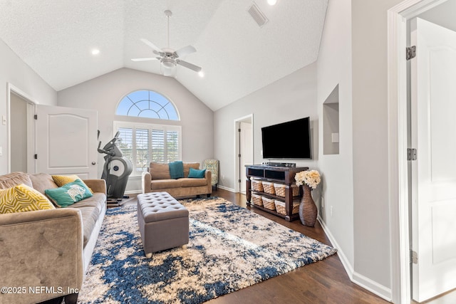 living room with a textured ceiling, dark wood-type flooring, high vaulted ceiling, and ceiling fan