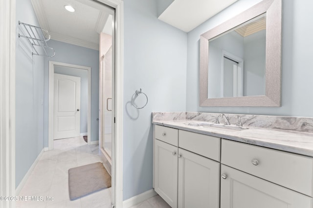 bathroom with ornamental molding, vanity, and a shower with shower door