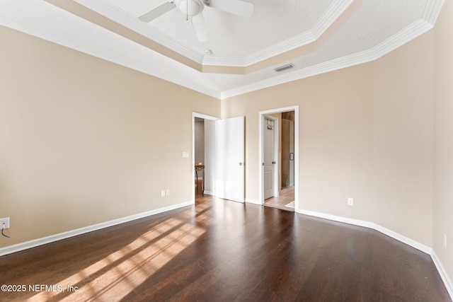 unfurnished room with a tray ceiling, wood-type flooring, ornamental molding, and ceiling fan