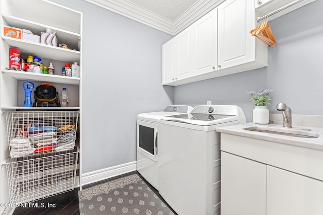 washroom with dark hardwood / wood-style floors, sink, cabinets, ornamental molding, and washer and clothes dryer