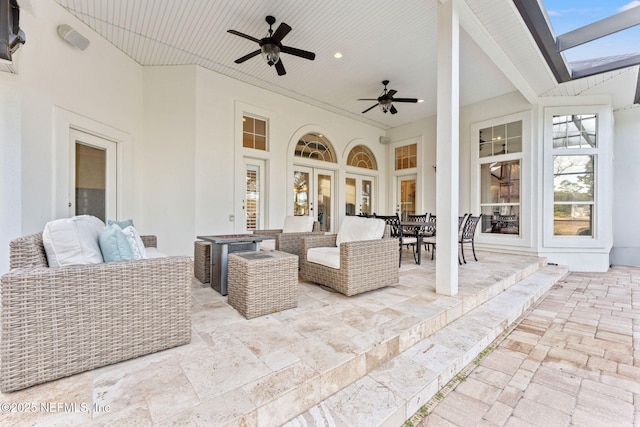 view of patio / terrace featuring an outdoor living space with a fire pit and ceiling fan