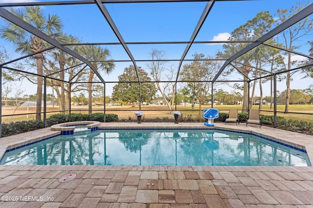 view of pool with a lanai, a patio, and an in ground hot tub