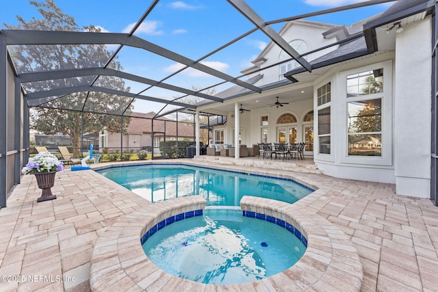 view of swimming pool featuring an in ground hot tub, ceiling fan, a patio, and glass enclosure