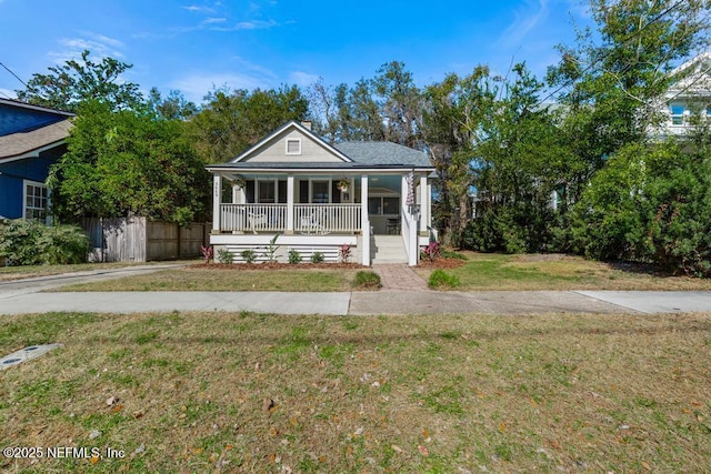 view of front of property with covered porch and a front yard