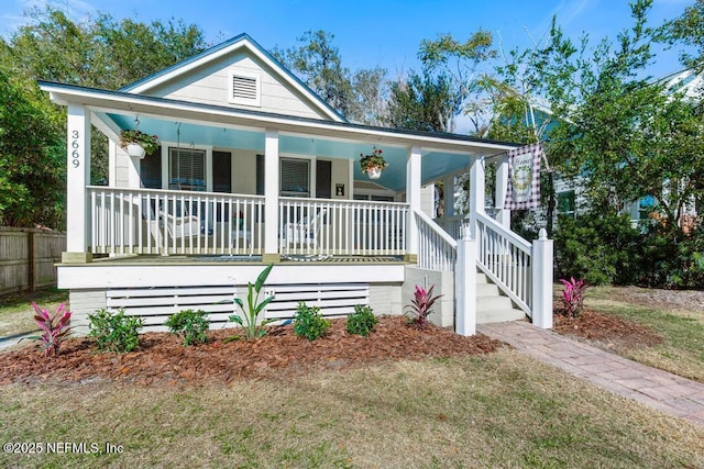 view of front of property with covered porch and a front lawn