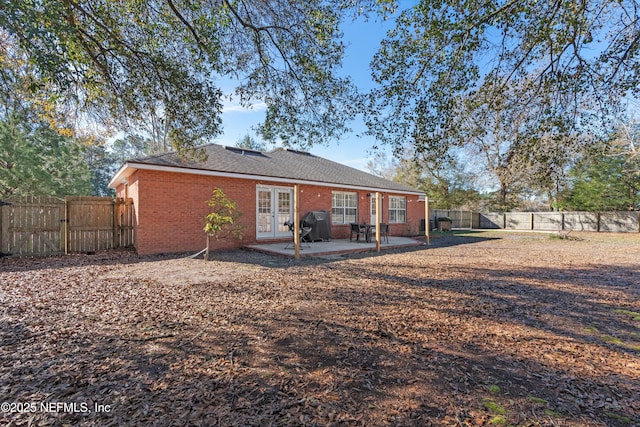 rear view of house featuring french doors and a patio area