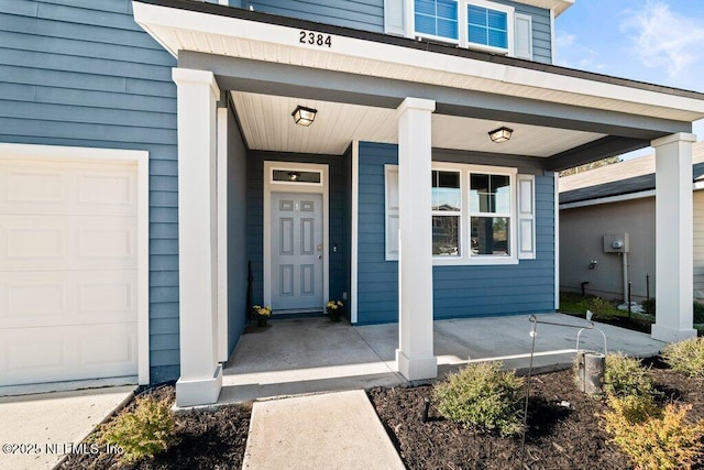 property entrance with a garage and a porch