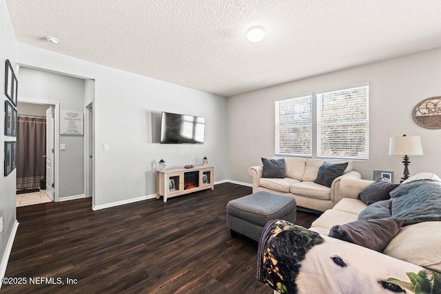 living room featuring dark hardwood / wood-style flooring and a textured ceiling