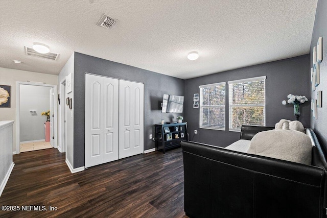 living room featuring dark hardwood / wood-style flooring and a textured ceiling