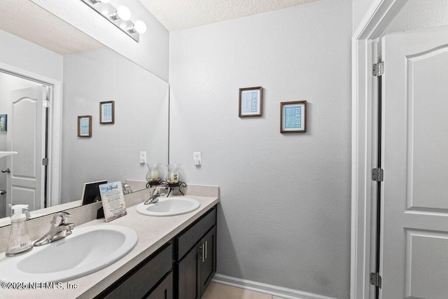 bathroom featuring vanity and a textured ceiling