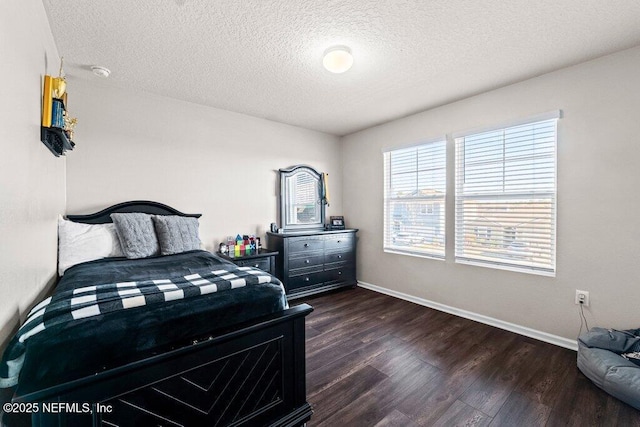 bedroom featuring dark hardwood / wood-style flooring and a textured ceiling