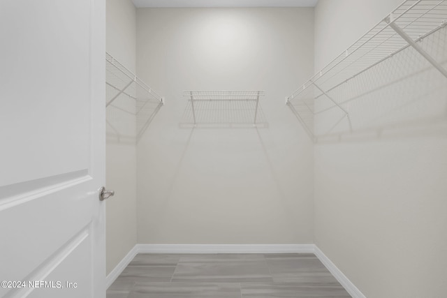 spacious closet with tile patterned flooring