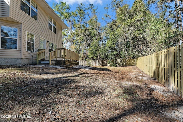 view of yard featuring a wooden deck