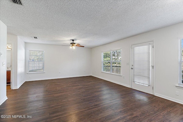 spare room featuring a textured ceiling, dark hardwood / wood-style floors, and ceiling fan