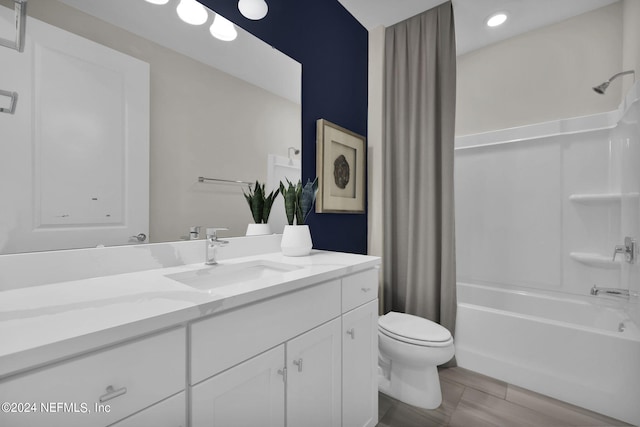 full bathroom featuring vanity, shower / bath combination with curtain, and toilet