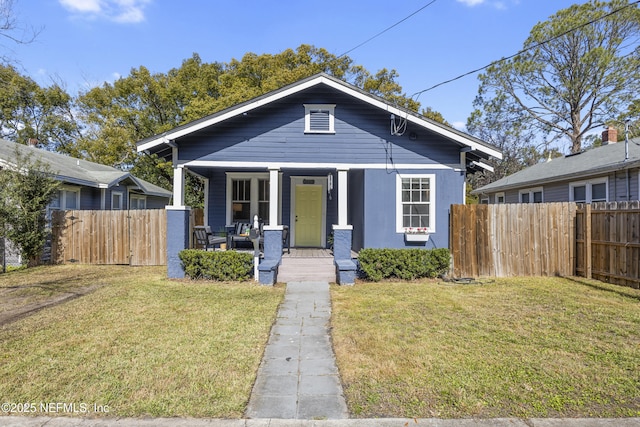 bungalow with a porch and a front yard