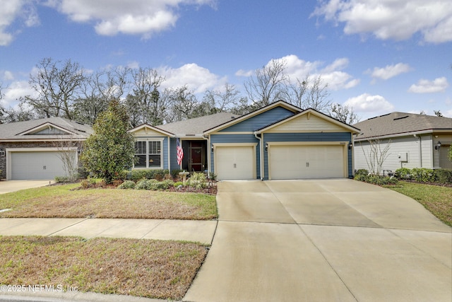 ranch-style home with a garage, concrete driveway, and a front lawn