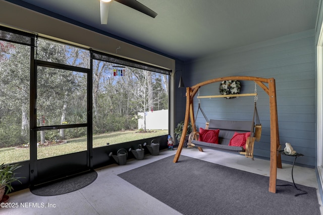 sunroom / solarium with a ceiling fan