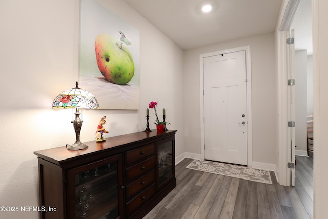 foyer entrance featuring wood finished floors and baseboards