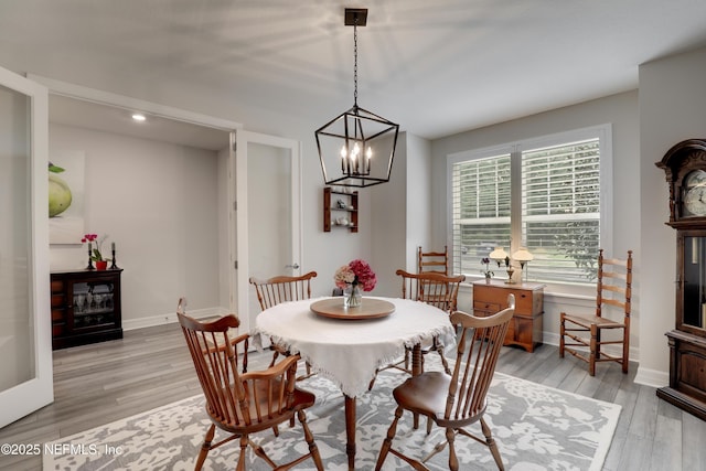 dining room with light wood-style flooring and baseboards