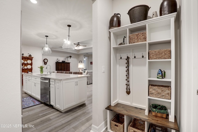 mudroom featuring a sink, light wood-style flooring, and baseboards