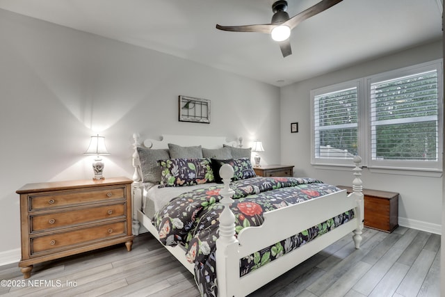 bedroom with ceiling fan, baseboards, and wood finished floors