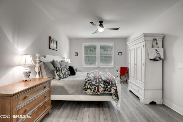 bedroom with ceiling fan, baseboards, and wood finished floors