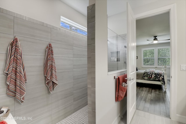 ensuite bathroom featuring a ceiling fan, walk in shower, a wealth of natural light, and ensuite bathroom