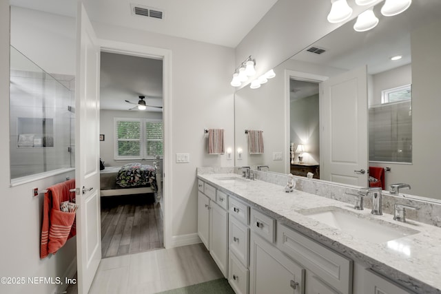 bathroom with a sink, connected bathroom, and visible vents