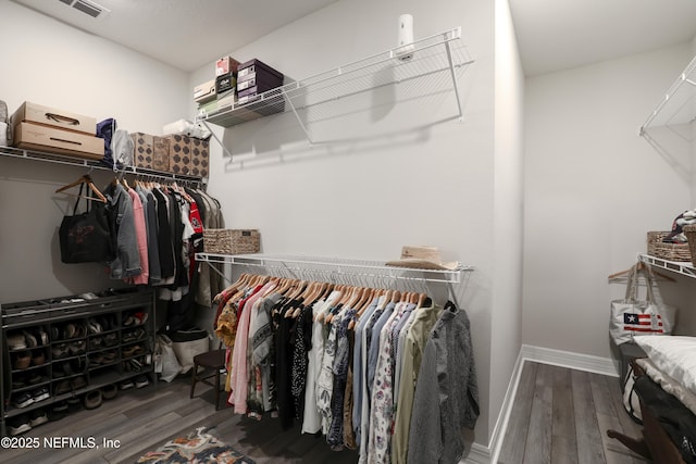 walk in closet featuring wood finished floors and visible vents