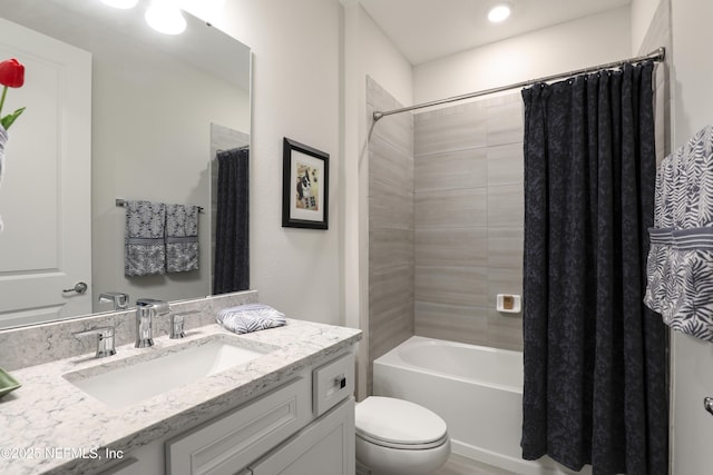 bathroom featuring shower / bath combo, vanity, and toilet