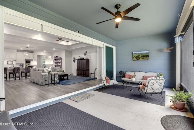 interior space with ceiling fan, an outdoor living space, and a wooden deck