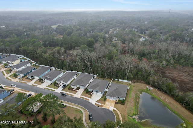 birds eye view of property featuring a residential view and a forest view