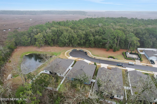 aerial view featuring a water view and a wooded view