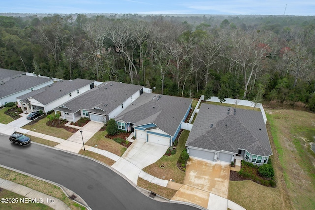 birds eye view of property featuring a wooded view