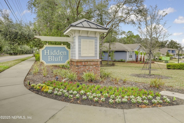 community / neighborhood sign with a lawn